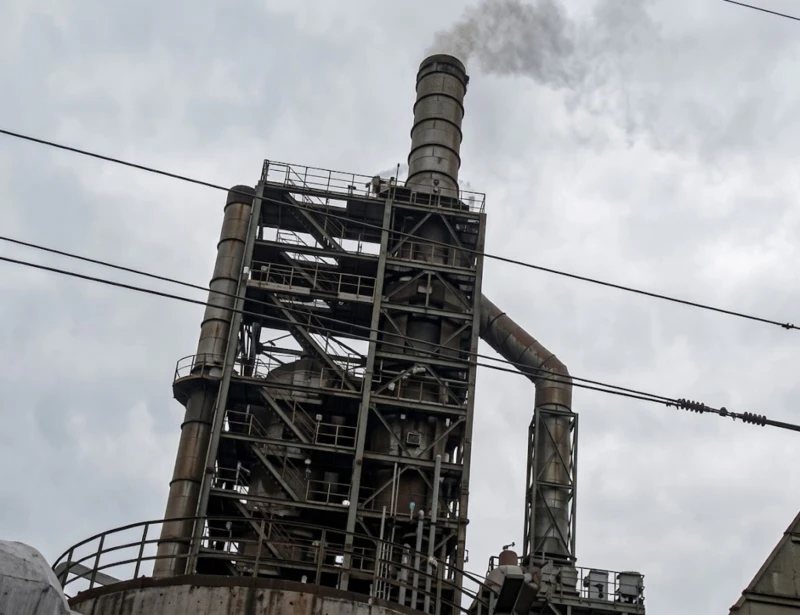 Magnetic Plume Abatement system in closed standby mode showing dense visible white plume rising from antibiotic pharmaceutical chain-grate boiler stack in northern China cold-climate conditions before system activation